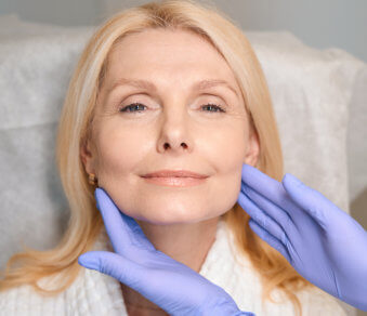 Woman receiving facial treatment