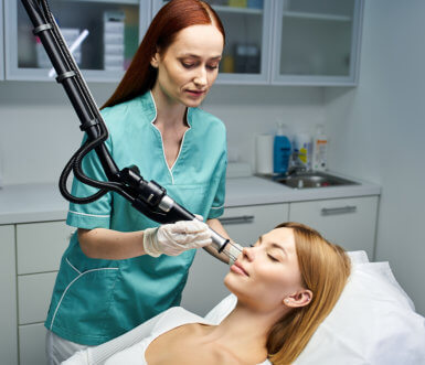 Clinician performing Tetra Pro laser treatment on patient